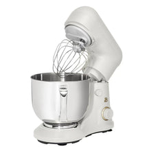 White stand mixer with stainless bowl and balloon whisk attachment