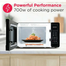 Black countertop microwave oven with open door and food inside the cavity
