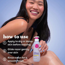 Cashmere shave oil bottle held in hand, pink cap and label facing forward
