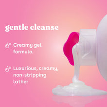 Creamy gel body wash dispensing onto a surface, soft white foam.