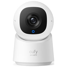 Indoor security camera with white dome, black lens, and small blue status light