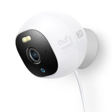 White wired outdoor surveillance camera with spotlight and wide-angle lens