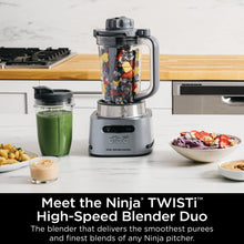 Gray Ninja TWISTi blender base with clear jar and mixed fruit and vegetables inside