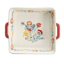 Square ceramic baking dish with red side handles and centered floral bird bouquet design