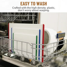 Three plastic cutting boards with multicolor edges in a dish rack, handle holes visible