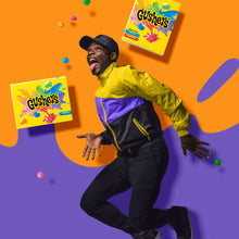 Person reaching with multiple Gushers variety pack boxes floating above