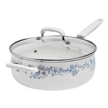 White ceramic saucepan with blue floral pattern, glass lid, and white side handle