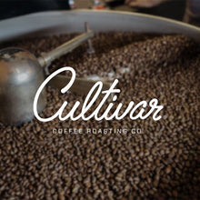 Cultivar dark roasted coffee beans with brand logo.