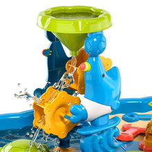 Sand and water table water feature with blue dinosaur figure, yellow tools, and green funnel