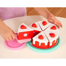 Sliced cake and dessert accessories with red strawberry shapes on a tray