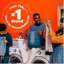 Tide liquid detergent container being held while people use laundry machines