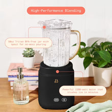 Black blender with clear handled jar and gold-tone handle accent