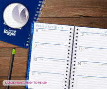 Spiral planner open to February 8–14 weekly layout with ruled notes lines