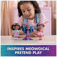 Child with three winter-themed Gabby dolls on a tabletop, colorful outfits
