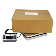 Postal shipping scale with cardboard box on platform and blue display reading 7.80