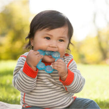 Blue circular water teether in baby’s hands with bumpy water texture