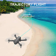 Quadcopter drone flying along a marked trajectory over a sandy shoreline