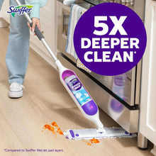 Power mop with purple control top and striped pad cleaning hardwood floor