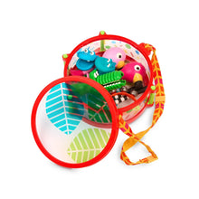 Opened red animal toy drum case with green, pink, and blue instrument attachments