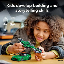 Kids building play set with green LEGO race car models on a table