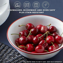 White glass serving bowl with red rim and swirl pattern, filled with cherries