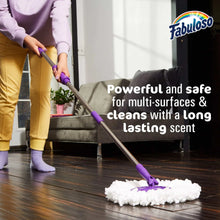 All purpose cleaner bottle with purple mop and white foam on dark wood floor