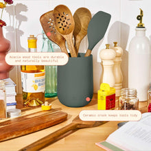 Kitchen tools set: dark green stoneware crock with wooden utensils