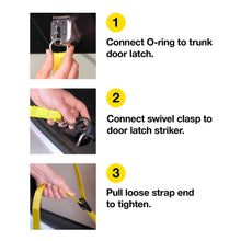 Hands showing yellow trunk strap hardware: O-ring, swivel clasp, and tightening end