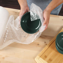 Clear bubble cushion wrap protecting a bowl on a wooden tabletop