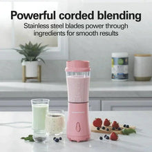 Coral personal blender with clear jar standing on a kitchen counter