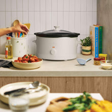 bella slow cooker with dark lid and white body, temperature knob centered