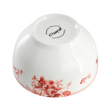 White stoneware bowl with red floral rim and printed base logo