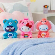 Pink cheer bear plush with red bow and rainbow belly, among other plush friends