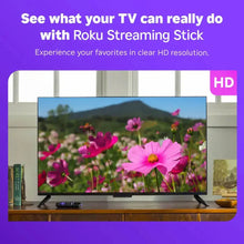 Roku streaming stick displayed with TV playing HD flower video