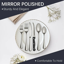 Mirror polished stainless steel cutlery set on a round tray with forks, spoons, and knives