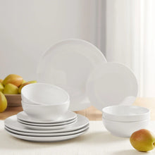 White glazed dinnerware set with stacked plates and bowls
