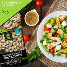 Roasted salted pistachios bag with serving bowl of salad and hard-boiled eggs