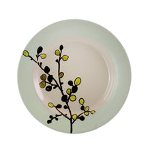 Green-rim stoneware dinner plate with centered floral branch motif