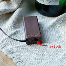 LED light battery pack with switch and cable connection on a fabric surface