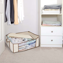 Beige compression bag tote with open top, containing folded clothes, on carpet floor