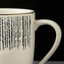 Stoneware mug rim with black drip band and white handle
