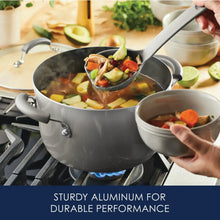 Gray nonstick pot on stovetop with ladle serving vegetables and broth