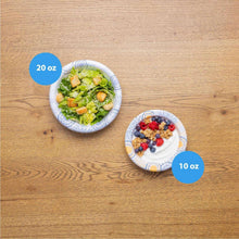 Disposable paper bowls on wood: vegetable salad 20 oz and berry dish 10 oz