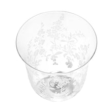 Clear glass tumbler with white floral etching, viewed from the top