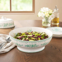 11-inch stoneware serving bowl with green floral rim, filled with salad