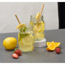 Two clear mason jars with lemon slices and mint, regular mouth jars with gold lids
