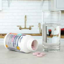 Multivitamin supplement bottle with pink tablets and clear water glass.