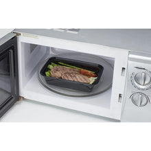 Meal prep food storage container in microwave, dark base with clear lid