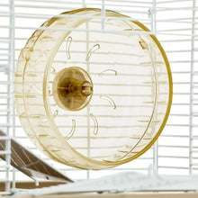 Clear running wheel with tan center inside a white wire hamster habitat