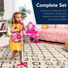 Pink kids flash guitar toy with microphone and stand, being played by a child